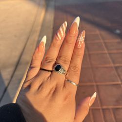 A La Mode Nail Spa & Lounge - Gel x, hand painted designs and glitter on index and ring finger