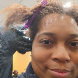 Empire Beauty School - Wendy professionally applying the base before the relaxer.