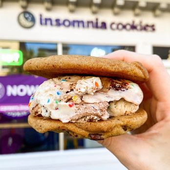 Insomnia Cookies - a hand holding a cookie sandwich - Desserts Near Me - Blacksburg, Virginia Insomnia Cookies - a hand holding a cookie sandwich - Desserts Near Me - Blacksburg, Virginia