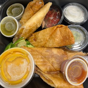 Tijuana Flats - Flautas - with refried beans. Includes sour cream, guac, salsa, and queso - Mexican Near Me - Lakeland, Florida Tijuana Flats - Flautas - with refried beans. Includes sour cream, guac, salsa, and queso - Mexican Near Me - Lakeland, Florida
