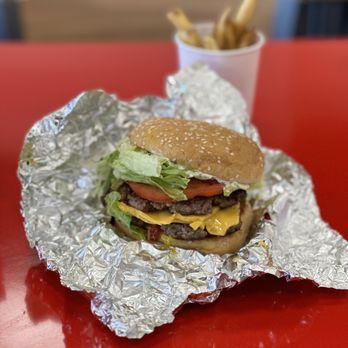 Five Guys - a hamburger and french fries on a red table - Burgers Near Me - Tucker, Georgia Five Guys - a hamburger and french fries on a red table - Burgers Near Me - Tucker, Georgia