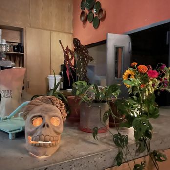Sobre Masa - a kitchen counter with flowers and a skull - Mexican Near Me - Brooklyn, New York