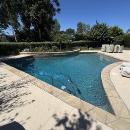 Old pool concrete deck, tile, and dark bottom pool.