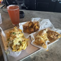 Garlic fries, garlic Parmesan wings, Malaysian curry rub wings, and a blood orange beer Garlic fries, garlic Parmesan wings, Malaysian curry rub wings, and a blood orange beer