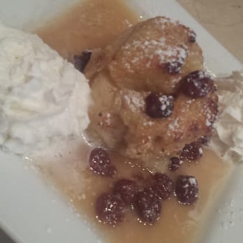 Cyrano's - Bread Pudding with a cherry bourbon sauce and whip cream - Desserts Near Me - Saint Louis, Missouri