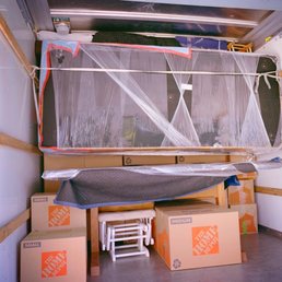 Couch suspended above dining table. It utilized every inch of truck space and protected our table from the couch's weight!