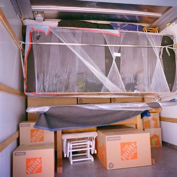 Elite Movers & Packing Services - Couch suspended above dining table. It utilized every inch of truck space and protected our table from the couch's weight! - Movers Near Me - Oxnard, California