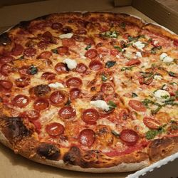 Half and half with pepperoni and garlic pesto delight.