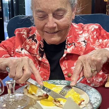 Pangea Global Teahouse - Mom enjoying her Eggs Benedict. She dug right in! Lol - Tea Rooms Near Me - Watkins Glen, New York
