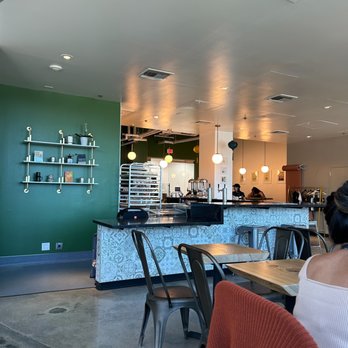 Little Green Cyclo Bistro - a woman sitting at a table - Vietnamese Near Me - Brisbane, California Little Green Cyclo Bistro - a woman sitting at a table - Vietnamese Near Me - Brisbane, California
