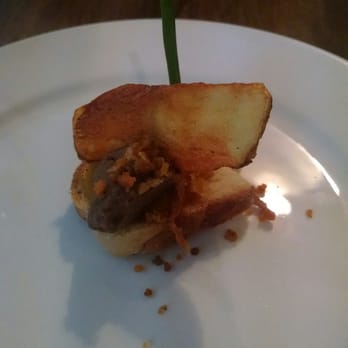 Tosnu - The amuse-bouche, an olive-lentil tapenade atop a schmear of carrot-ginger on a crostini - Irish Near Me - Galway, G