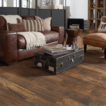 Floors For Living - a living room with a brown leather couch - Flooring Near Me - Cypress, Texas Floors For Living - a living room with a brown leather couch - Flooring Near Me - Cypress, Texas