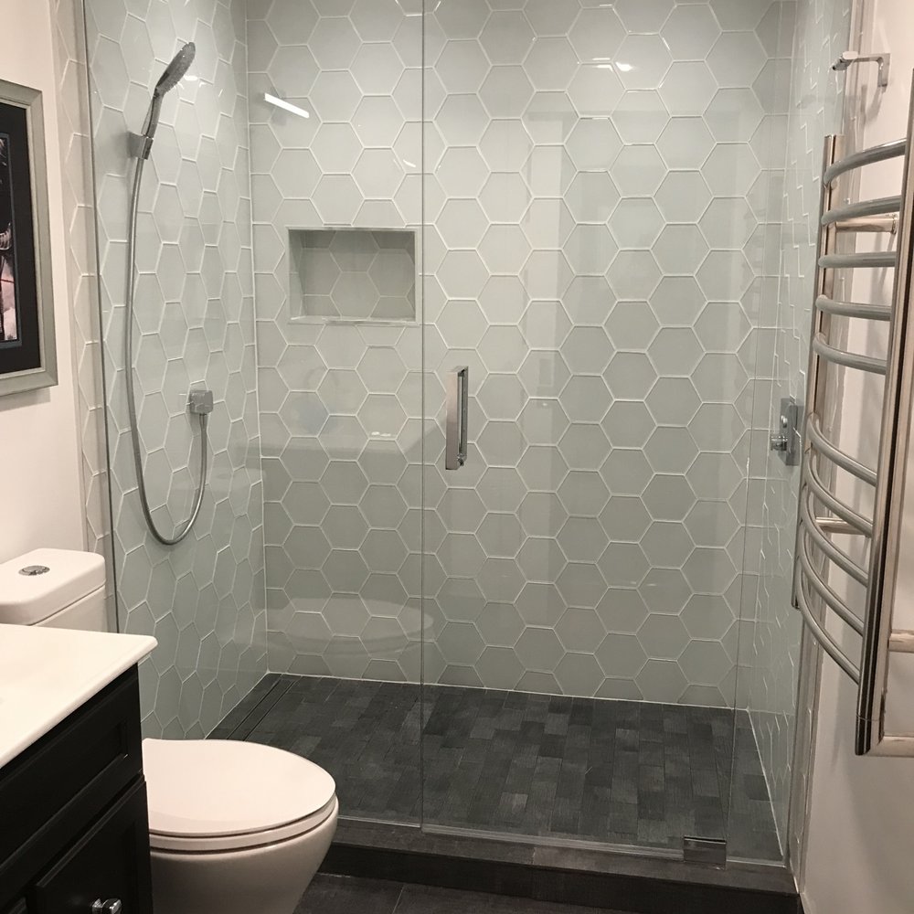 The after picture of the entire minimalist black and white bathroom