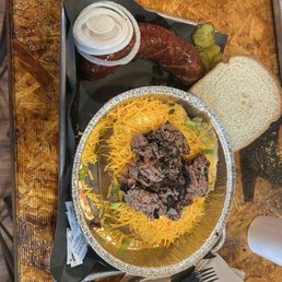 Loaded Spud with brisket and sausage on the side. Loaded Spud with brisket and sausage on the side.