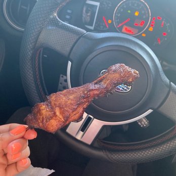 First Wok - a hand holding a piece of meat in front of a steering wheel - Chinese Near Me - Greenville, South Carolina First Wok - a hand holding a piece of meat in front of a steering wheel - Chinese Near Me - Greenville, South Carolina