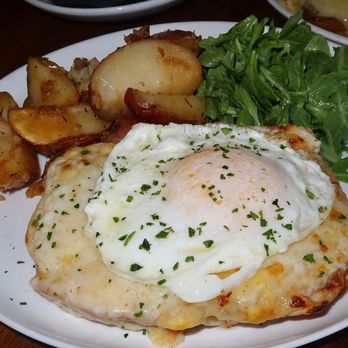 Le French - The Croque Madame was made with classic Parisian ham, gruyère, béchamel, fried egg, & served alongside a mixed green salad. - French Near Me - Denver, Colorado Le French - The Croque Madame was made with classic Parisian ham, gruyère, béchamel, fried egg, & served alongside a mixed green salad. - French Near Me - Denver, Colorado