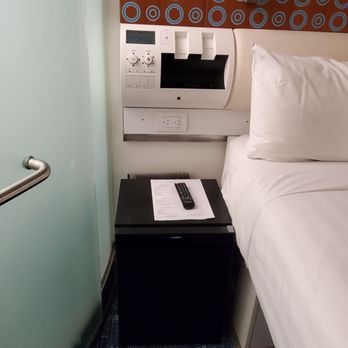 Breakfree On Cashel - Mini-fridge and weird alarm clock by bed - Hotels Near Me - Christchurch, CAN
