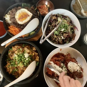 ANJU - Clockwise from top left: bibim bop with bulgogi, lamb noodles, fried chicken, and kimchi fried rice. Everything was delicious!! - Korean Near Me - Washington, DC, District of Columbia