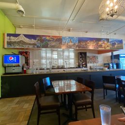 a restaurant with a large mural on the wall