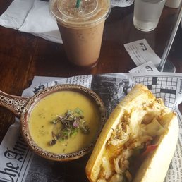 A chicken Philly cheese steak sandwich with  creamy poblano soup.