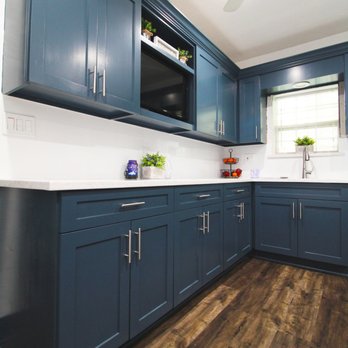 Strong Tower Renovations - a kitchen with blue cabinets - General Contractors Near Me