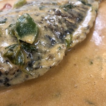 La Cocina - a fish covered in sauce - Latin American Near Me - Providence, Rhode Island