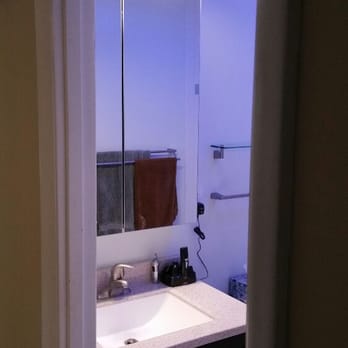 Blair Contracting - a bathroom with a sink and mirror - General Contractors Near Me Blair Contracting - a bathroom with a sink and mirror - General Contractors Near Me