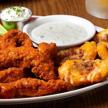 99 Restaurants - a plate of chicken wings and celery sticks - American Near Me - Tilton, New Hampshire