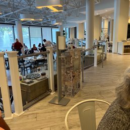 a dog sitting at a table in a restaurant a dog sitting at a table in a restaurant