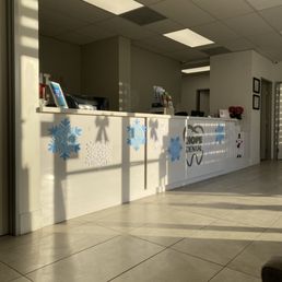 Clean office, helpful staff, air conditioning, comfortable seating, and calm music.