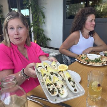 Wit & Wisdom - Caesar salad and pizza in the background. - New American Near Me - Sonoma, California Wit & Wisdom - Caesar salad and pizza in the background. - New American Near Me - Sonoma, California