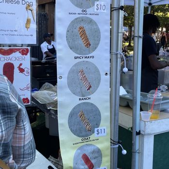 Puffle Up - a man standing in front of a food stand - Desserts Near Me