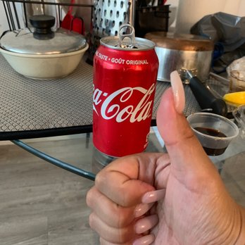 Phosome - a hand holding a can of coke - Vietnamese Near Me - Toronto, Ontario