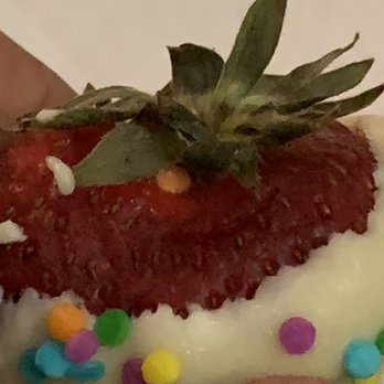 Edible Arrangements - a hand holding a strawberry with sprinkles - Florists Near Me - Hamden, Connecticut