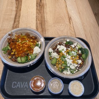 CAVA - Baby Spinach, Brown Rice, Harissa Honey Chicken, Fire Roasted Corn, Persian Cucumbers, Crumbled Feta with Hot Harissa Vinaigrette Dressing. - Salad Near Me - Charlotte, North Carolina