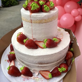 Schwartz Bakery & Cafe - a three tiered cake with strawberries on top - Bakeries Near Me - Los Angeles, California