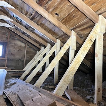 Perspective Construction - an attic with wooden beams - General Contractors Near Me