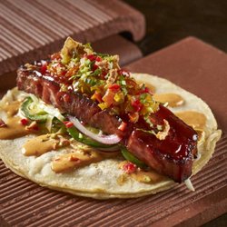 Taco Bamba City Ridge - Hey Zeus taco nuestro with mumbo bacon, chipotle mustard, jalapeno slaw, tomatillo chow chow, pickled fresno, crispy onion, c...