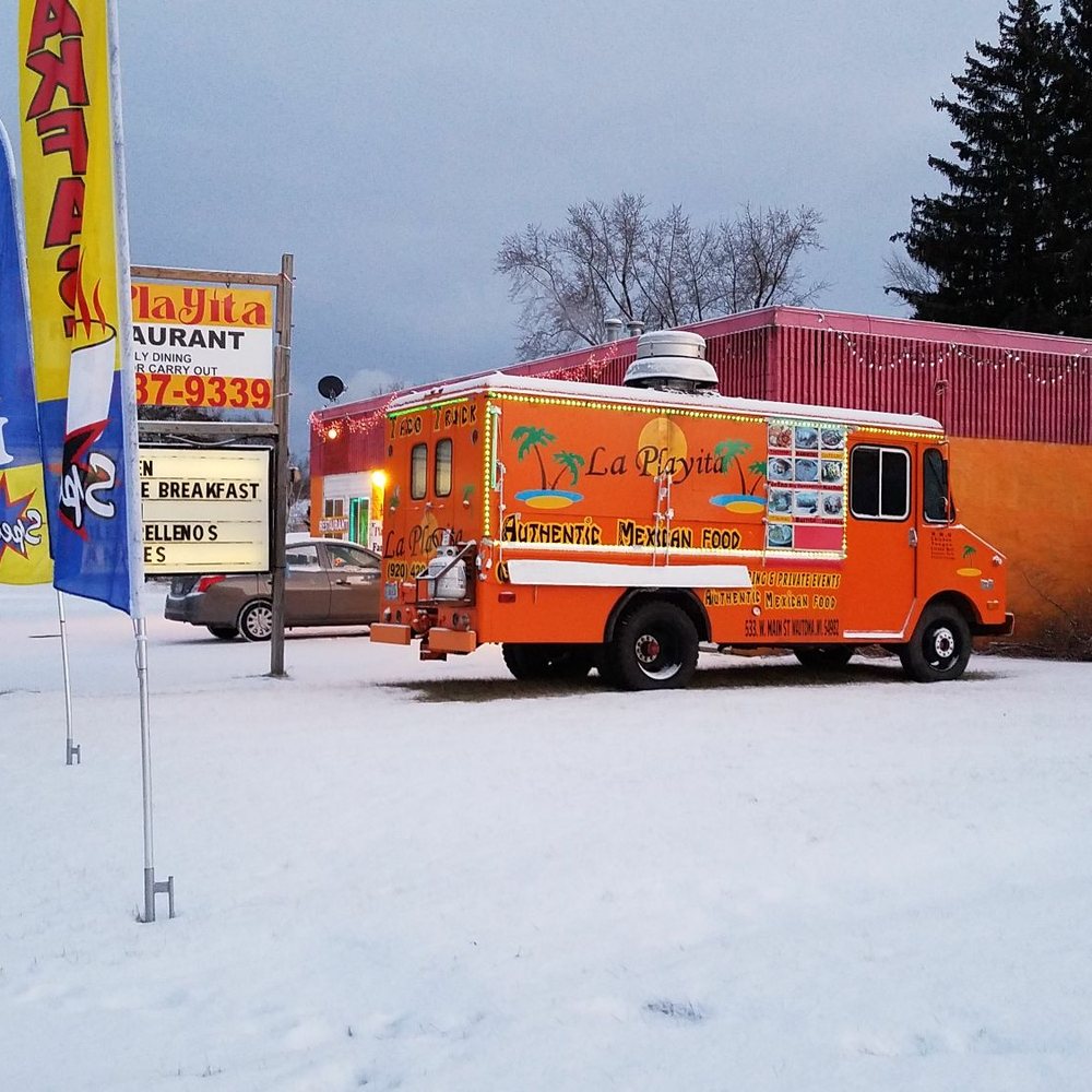 a food truck parked in the snow a food truck parked in the snow