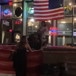 a man and a woman standing in front of a bar a man and a woman standing in front of a bar