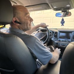 Ace Taxi - Driver Shane at steering wheel