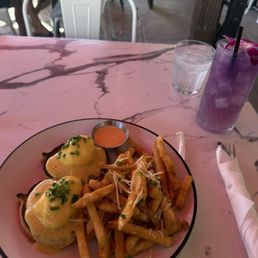 Eggs benny with truffle fries and butterfly pea flower lemonade