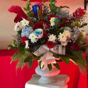 Blooms By Marie - This arrangement was created for the deceased to reflect all his work in placing children with families to brighten their lives. - Florists Near Me - Albany, New York