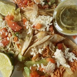 El Oasis - Chicken tacos (with lettuce, cheese, and tomato), with green cilantro sauce (on the side)