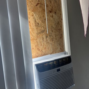 Araali Construction - window a/c unit, plywood BEFORE - TV Mounting Near Me