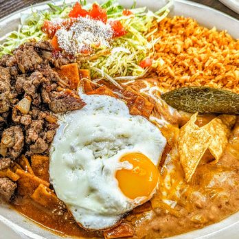 Ortega's Diner - Chilaquiles with red sauce and carne asada Sunny side up egg, rice and beans and shredded lettuce with tomatoes and queso Blanco - Mexican Near Me - Fontana, California Ortega's Diner - Chilaquiles with red sauce and carne asada Sunny side up egg, rice and beans and shredded lettuce with tomatoes and queso Blanco - Mexican Near Me - Fontana, California