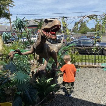 Eastside Big Tom - Dinosaur attacking child - Burgers Near Me - Olympia, Washington Eastside Big Tom - Dinosaur attacking child - Burgers Near Me - Olympia, Washington
