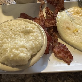 Mamas Kitchen - Bacon cooked crisp and grits. I ordered the eggs over hard and they were perfect. - Breakfast & Brunch Near Me - Seminole, Florida Mamas Kitchen - Bacon cooked crisp and grits. I ordered the eggs over hard and they were perfect. - Breakfast & Brunch Near Me - Seminole, Florida