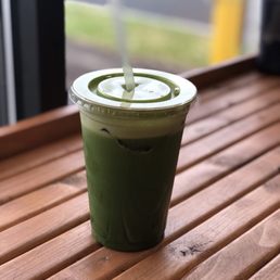 a green drink in a plastic cup