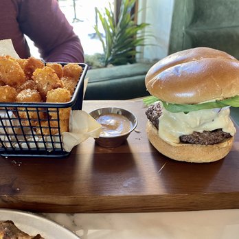 Farmers Commons - The burger. It's has a fried green tomato on it among a bunch of other good things. The tots were crispy perfection! - Comfort Food Near Me - Florence, Texas